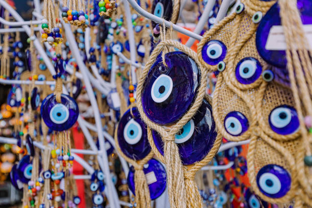istock Evil eye turkish bead amulets hanging in souvenir store. Gift and superstitions concept 1413039971