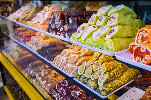 Various Turkish delights sweets and traditional authentic candy for sale at market showcase. Tasty shop business concept