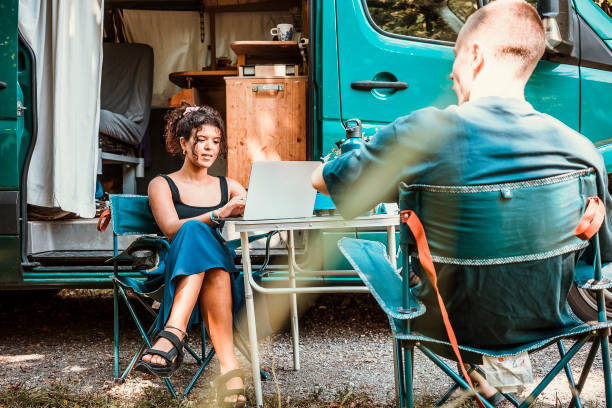 Couple camping in a van stock photo