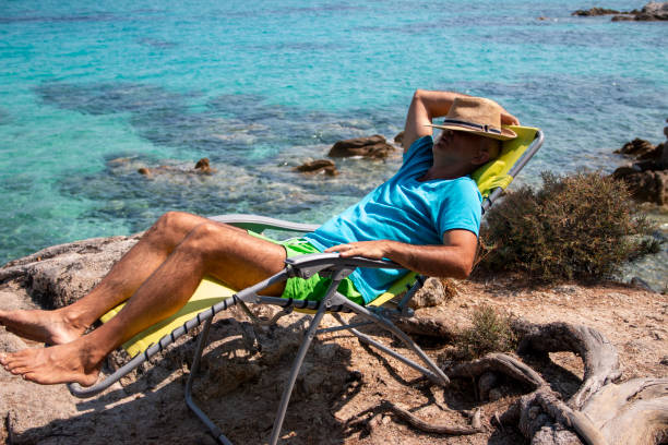 istock Portrait of a handsome man lying on a deckchair and resting. 1413040702