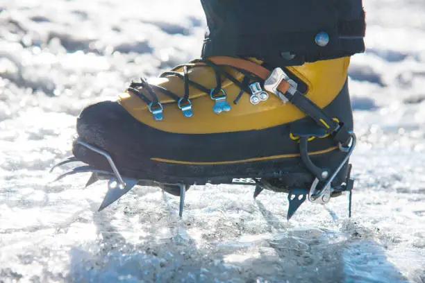Rigid step-in front-point crampons used for vertical ice climbing. A mountaineering boot equipped with a traditional 10-point glacier trekking crampon. Mountaineering Day - 8 August