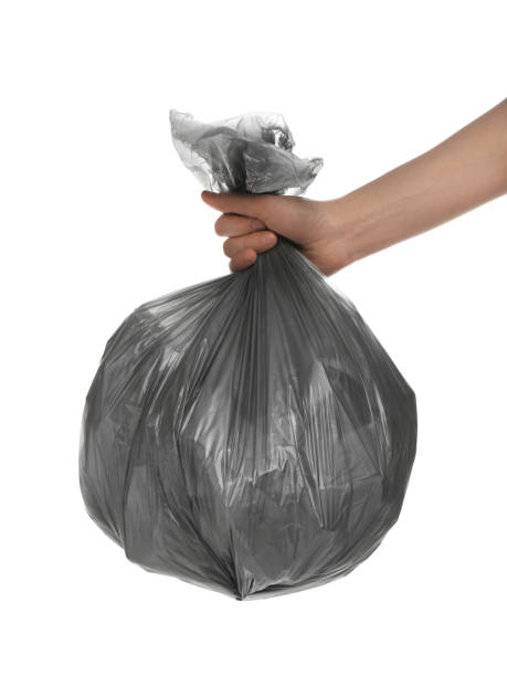 istock Woman holding trash bag filled with garbage on white background, closeup 1413041471