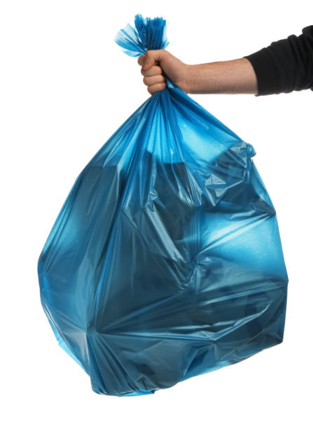 istock Man holding trash bag filled with garbage on white background, closeup 1413041472