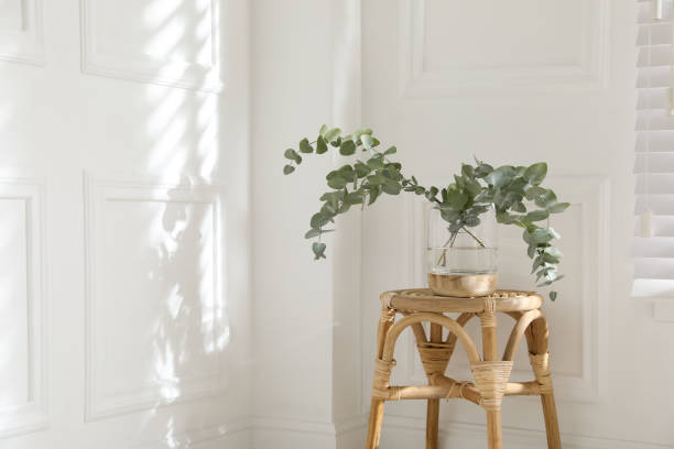 istock Beautiful eucalyptus branches in vase on wicker table indoors, space for text 1413041521