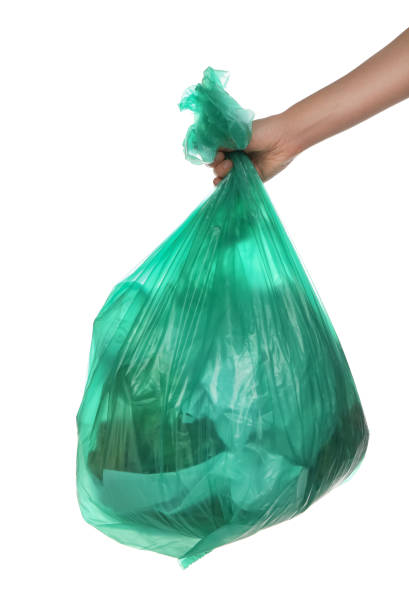 istock Woman holding trash bag filled with garbage on white background, closeup 1413041797