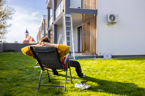 istock Tired man resting on deck chair in yard while coloring apartment 1413046736