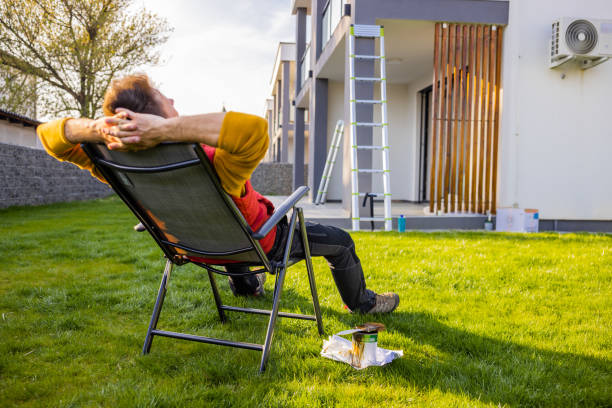 istock Tired man relaxing on deck chair in yard while coloring apartment 1413046771