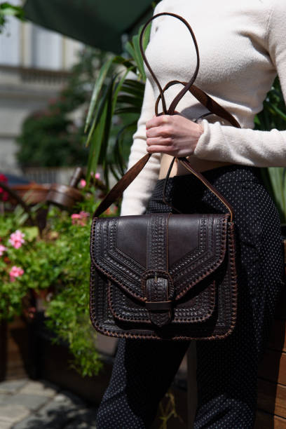 istock small brown women's leather bag with a carved pattern. selective focus 1413047266