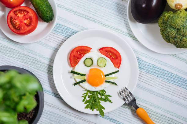 istock Creative and Fun Kids Breakfast Sunny Side Up Fried Egg with Vegetables Styled Like an Animal or Character 1413047466