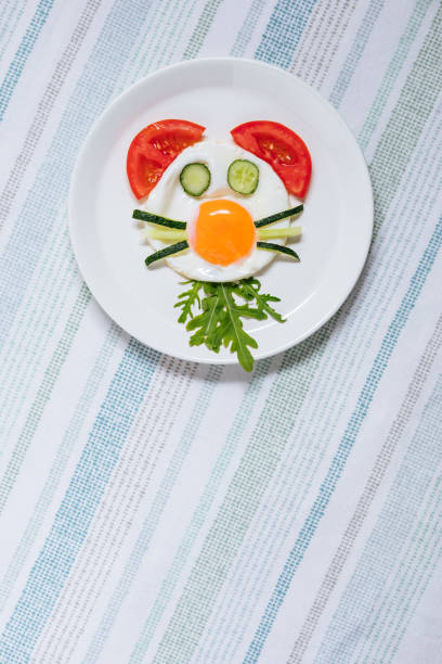 istock Creative and Fun Kids Breakfast Sunny Side Up Fried Egg with Vegetables Styled Like an Animal or Character 1413047492