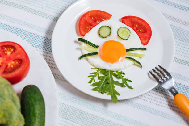 istock Creative and Fun Kids Breakfast Sunny Side Up Fried Egg with Vegetables Styled Like an Animal or Character 1413047498