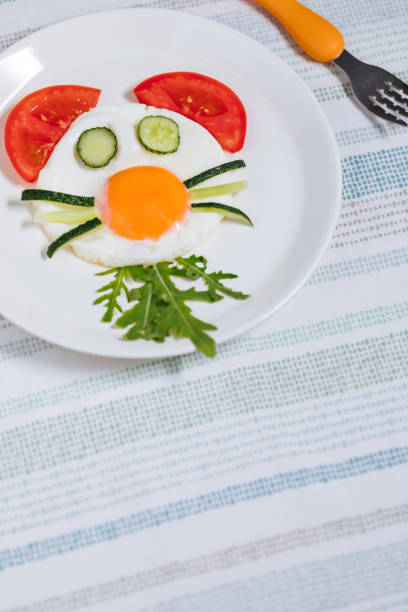 istock Creative and Fun Kids Breakfast Sunny Side Up Fried Egg with Vegetables Styled Like an Animal or Character 1413047505