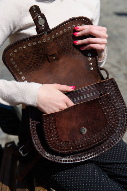 istock open small brown women's leather bag with a carved pattern. selective focus 1413047529