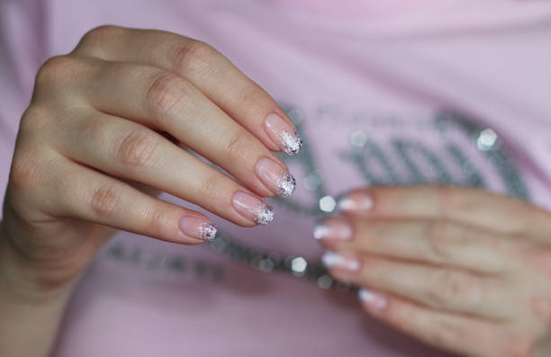 istock festive french manicure on two hands close-up glitter 1413048933