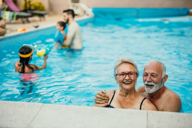 istock Senior couple enjoying a pool with a children 1413050209