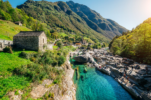 old roman bridge over turquoise river in the Verzasca valley in the Swiss Ticino Canton