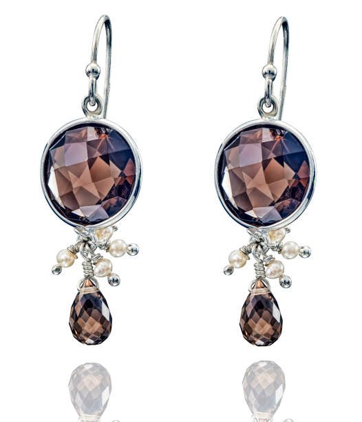 istock Golden earrings with gemstone isolated on white background 1413051224