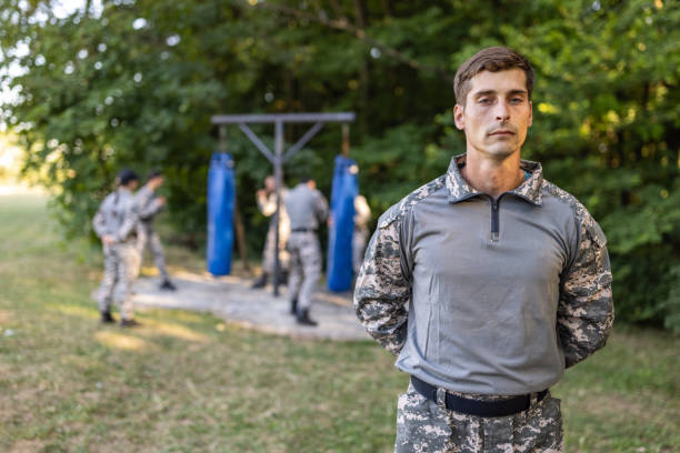 istock Portrait of male sargeant, while his team having an military training 1413051421