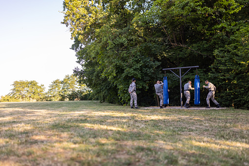 Caucasian female and male military team, having an outdoor military training, leaded by female sergeant