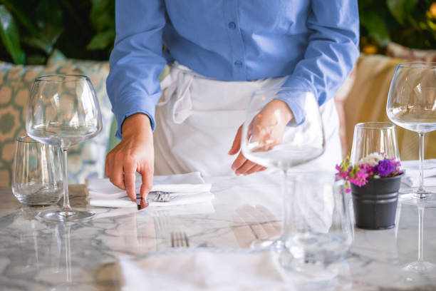 istock Waitress serving the empty table of the luxury restaurant 1413054390