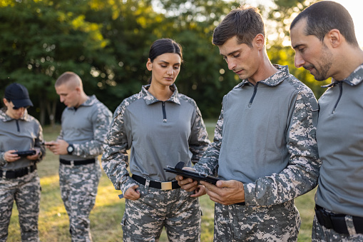 Caucasian female and male sargeant organizing the military training while using digital tablet