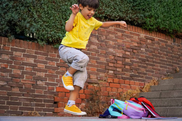 istock boy playing hopscotch on school playground. back to school concept. 1413056410