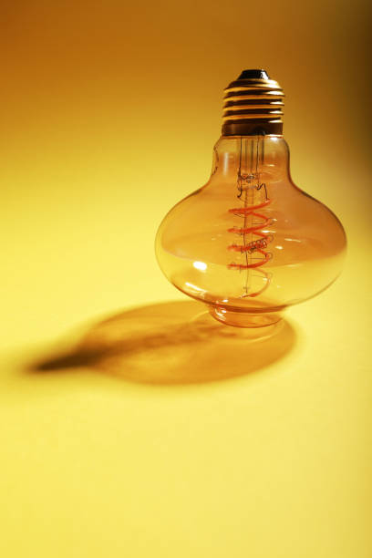 istock led bulb imitating filament bulb on yellow background and copy space 1413059329