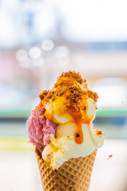 istock Ice cream cone with different flavor scoops sprinkled with crumbs 1413060899