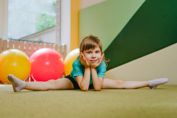 istock Little girl sitting on the twine looking at camera 1413061873