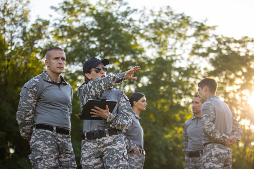 Caucasian female and male sargeant organizing the military training while using digital tablet