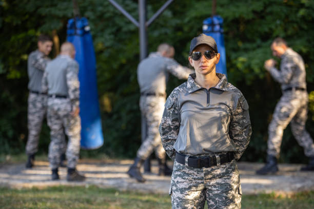 istock Portrait of female sargeant, while her team having an military training 1413062866