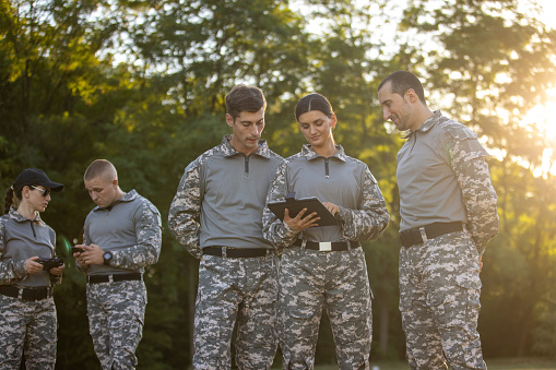 Caucasian female and male sargeant organizing the military training while using digital tablet