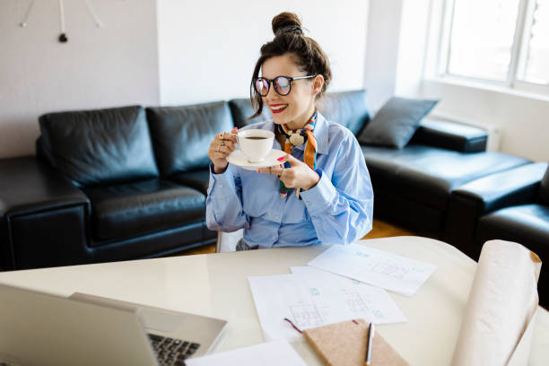 istock Positive woman video calling using laptop at home 1413062987