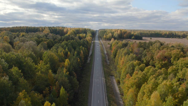 istock Asphalt road with traffic cars between forest in Ural 1413064621