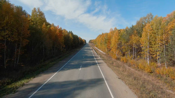istock FPV drone high-speed flight along the road and autumn forest in Ural 1413065593