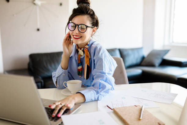 istock Positive woman video calling using laptop at home 1413065777