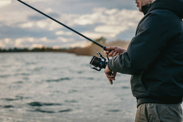 istock Young man fishing in river 1413067669