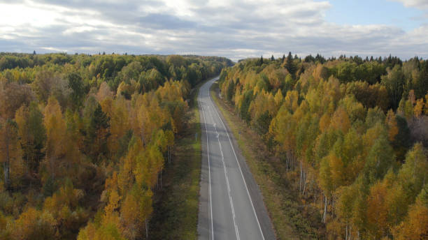 istock Asphalt road with traffic cars between forest in Ural 1413067696