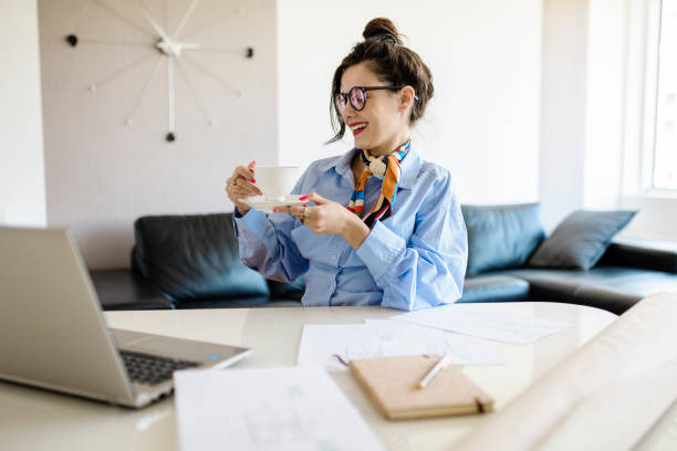 istock Positive woman video calling using laptop at home 1413067980