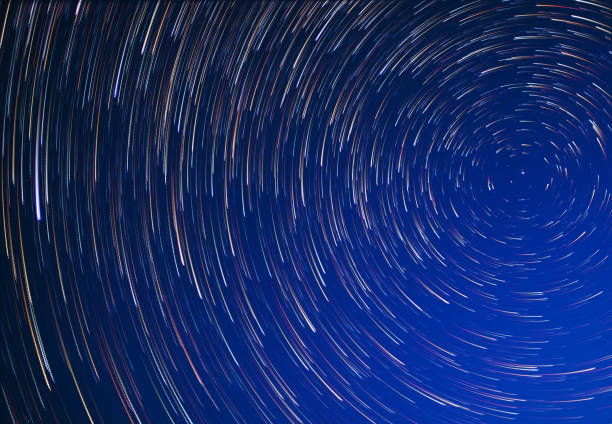 Stars move around the pole star at night. Long exposure stock photo