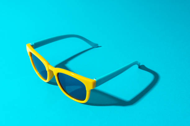 istock Plastic sunglasses on turquoise blue background in perspective with hard shadow 1413068187