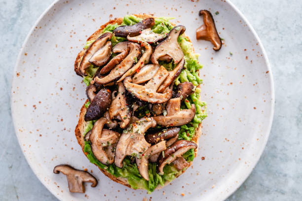 istock Toast with mashed avocado and shiitake mushrooms on a ceramic plate 1413069041
