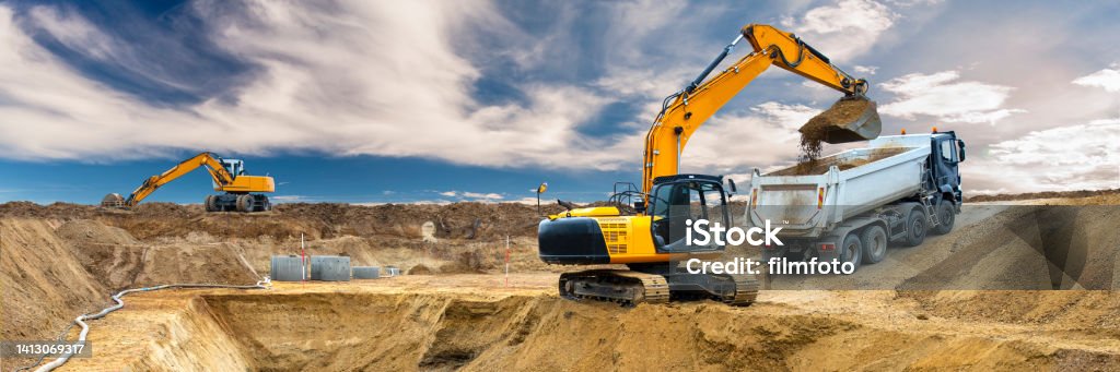excavator is digging on construction site Backhoe Stock Photo