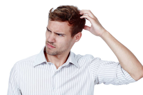 istock A confused young man scratching his head in studio isolated against a white background. Looking away and thinking, trying to make sense of the situation. A businessman has questions to ask 1413070441