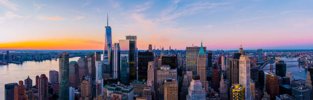 New York City Skyline A panoramic view of the New York City skyline at sunset new york city built structure building exterior aerial view stock pictures, royalty-free photos & images