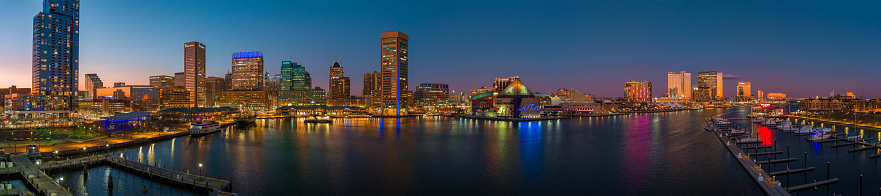 A panoramic aerial view of Baltimore's Inner Harbor at dusk