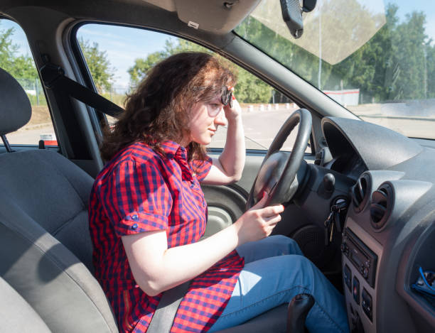 istock The girl driver studies the readings on the dashboard. 1413075032
