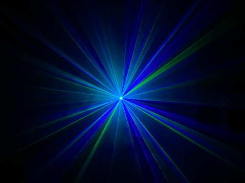 Colorful laser light beam photographic effect on black background. Nobody is visible.