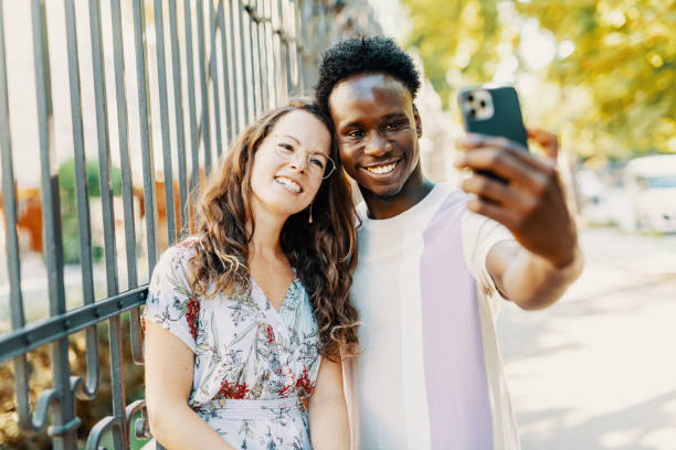 istock Diverse couple taking selfie and smiling 1413078838