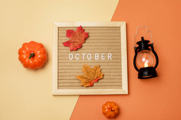 istock Yellow Letterboard with text October Black Flashlight Pumpkins Maple Leaf Autumn Decorations Holiday Card or Background on Orange and Yellow Background Autumn Greeting Card 1413078851